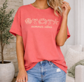 Woman wearing a red 'summer vibes' t-shirt and ripped jeans in a living room.