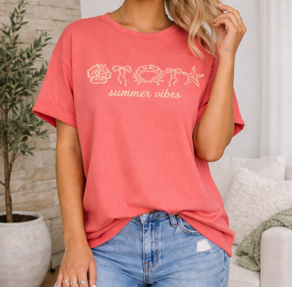 Woman wearing a red 'summer vibes' t-shirt and ripped jeans in a living room.